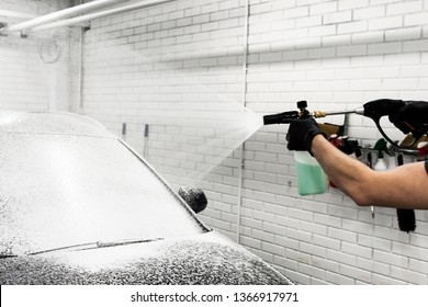 Washing black car with active foam, car wash with soap