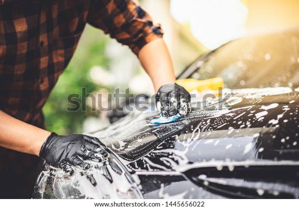 Washing
the black car. Car cleaning and car care
concept.