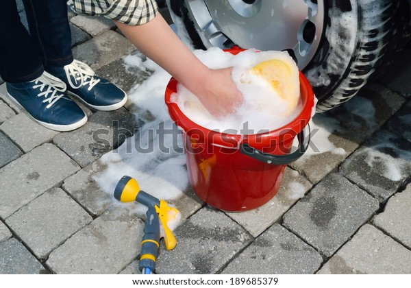 washing a car by\
hand