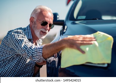 Washing Car. Senior Man Polishing His Car With Microfiber Cloth.