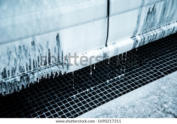 Washing car with soap. Close up clean car concept
at car wash.