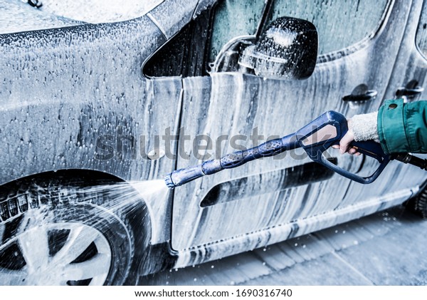 Washing car with soap. Close up clean car concept\
at car wash.