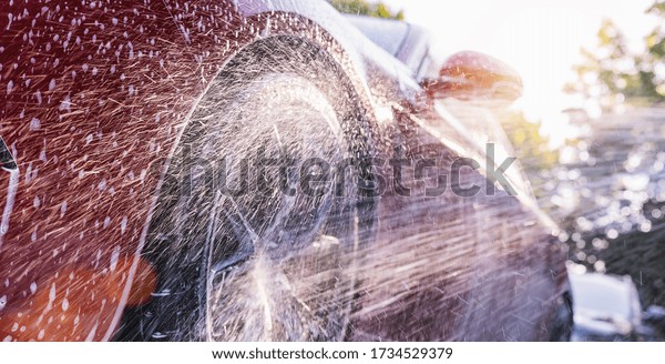 Washing car\
with soap. Close up Car Wash\
concept.