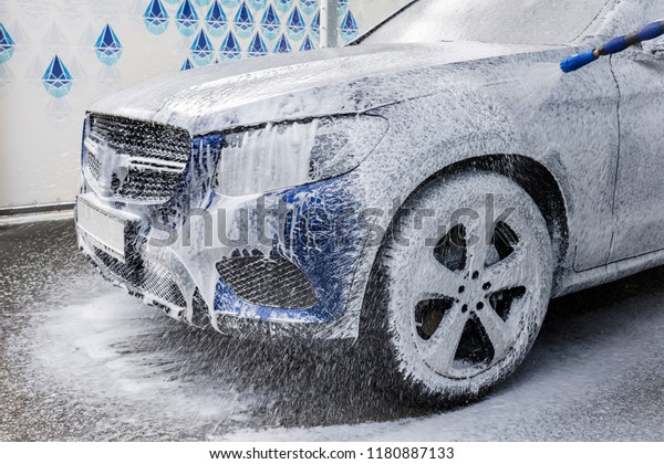 Washing car with soap.\
Close-up concept.