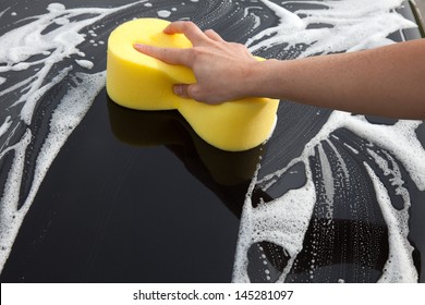 Washing A Car With A Sponge And Soap