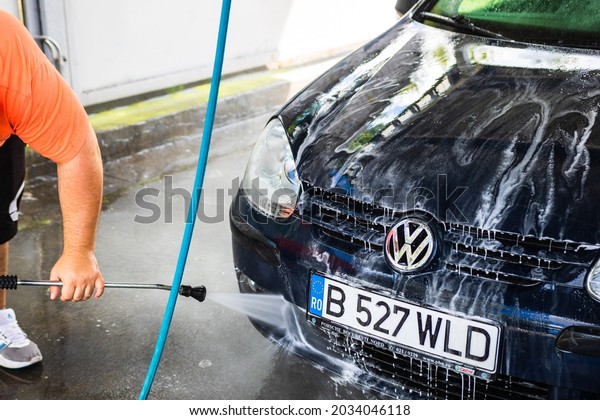 Washing and cleaning car in self service\
car wash station in Bucharest, Romania,\
2021