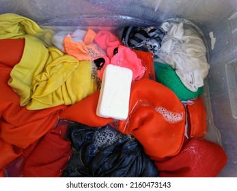 Washing Colorful Clothes In The Bucket 