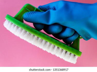 Washing concept. A hand with brush isolated on pink background. Worker cleaning. Cleaning with the foam and a brush. Cleaning concept. Hand in blue protective rubber glove - Powered by Shutterstock