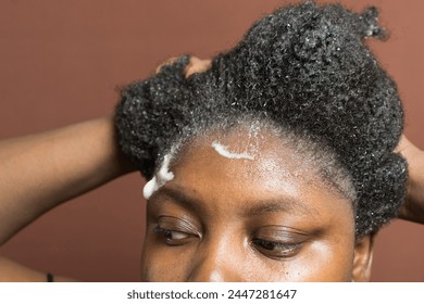 Washing curly hair with a shampoo, shampooing 4c coily hair, scrubbing curling hair during wash - Powered by Shutterstock