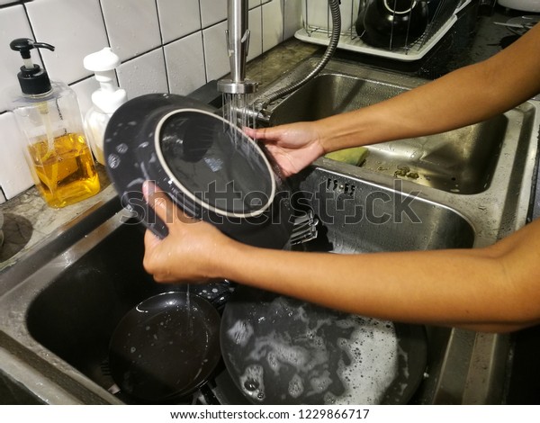 Washing dishes in\
kitchen