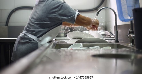 Washing The Dishes In Restaurant Kitchen