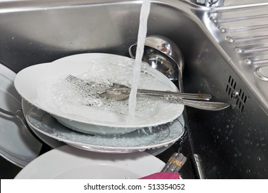 washing dishes in the sink in the kitchen