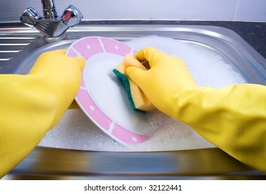 Washing Up Dishes With Yellow Gloves