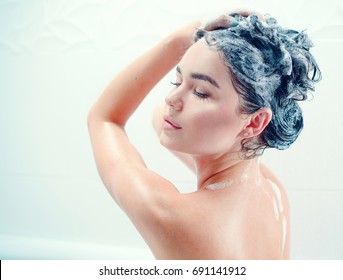 Washing Hair. Beautiful Naked Young Woman Is Smiling And Using Shampoo While Taking Shower In Bathroom. Beauty Sexy Model Girl Washing Her Long Black Hair