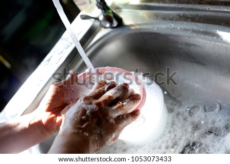 washing hand and dish in the kitchen in the morning