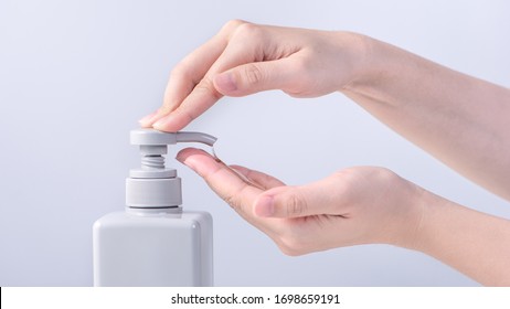 Washing Hands. Asian Young Woman Using Liquid Soap To Wash Hands, Concept Of Hygiene To Protective Pandemic Coronavirus Isolated On Gray White Background, Close Up.