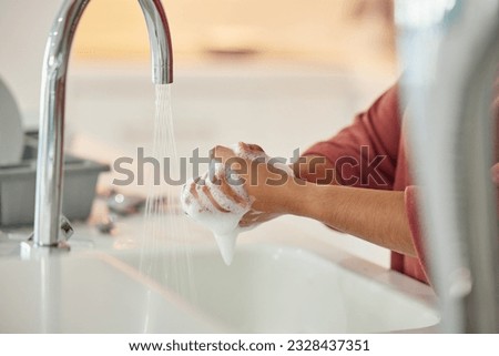 Washing hands, cleaning and person with hygiene and water for wellness in a kitchen faucet. Soap foam, sink and home with bacteria prevention and safety with disinfection with liquid before cooking