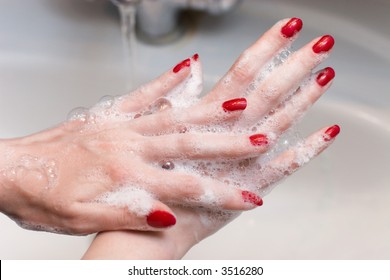 Washing Hands With Red Nails. Scene In A Bathroom.