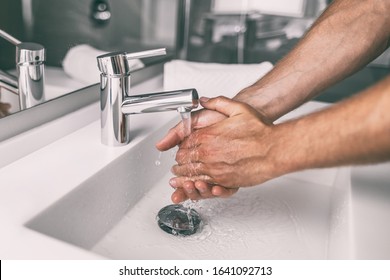 Washing hands rubbing with soap man for winter flu virus prevention, hygiene to stop spreading germs.