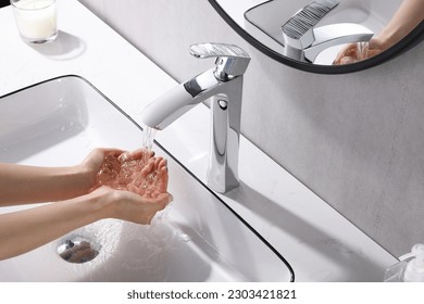 Washing hands under the flowing water tap. Washing hands rubbing with soap for corona virus prevention, hygiene to stop spreading corona virus in or public wash room. Hygiene concept hand detail - Powered by Shutterstock