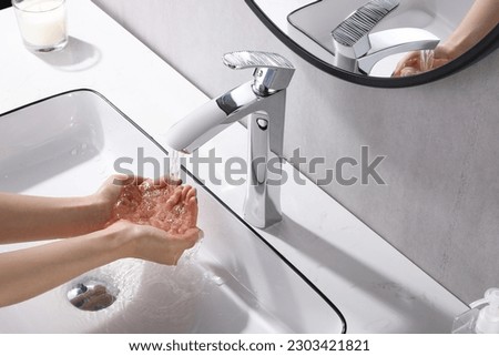 Washing hands under the flowing water tap. Washing hands rubbing with soap for corona virus prevention, hygiene to stop spreading corona virus in or public wash room. Hygiene concept hand detail