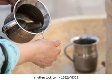 Washing hands using Jewish ritual cup. - Powered by Shutterstock