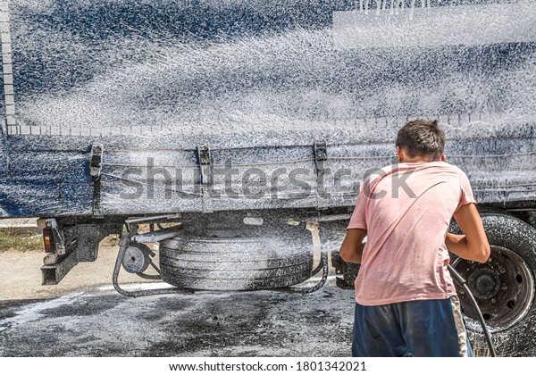 Washing a large truck with\
car shampoo