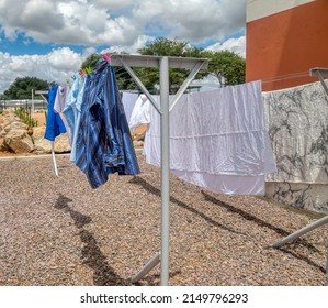 Washing Line With Clothes Drying  In The Backyard