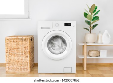 Washing machine with clothes in modern bathroom interior - Shutterstock ID 1420387862