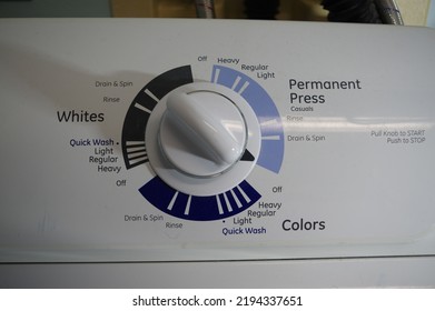 Washing machine control switch in off position, with wash options for colors, whites and permanent press. - Shutterstock ID 2194337651