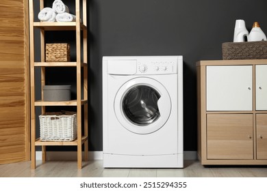 Washing machine, detergents in basket, wooden rack and storage cabinet indoors