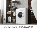 Washing machine and detergents in laundry room, low angle view