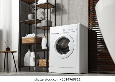 Washing machine and detergents in laundry room, low angle view