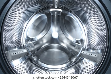 Washing machine with empty drum as background, closeup