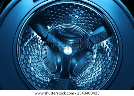 Washing machine with empty drum as background, closeup