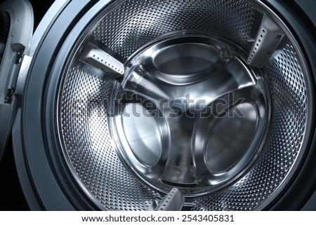 Washing machine with empty drum as background, closeup