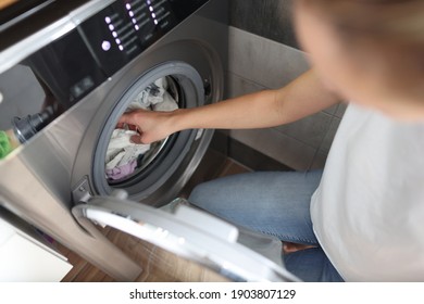 Washing machine is loaded with laundry for washing. Self-service laundry service concept