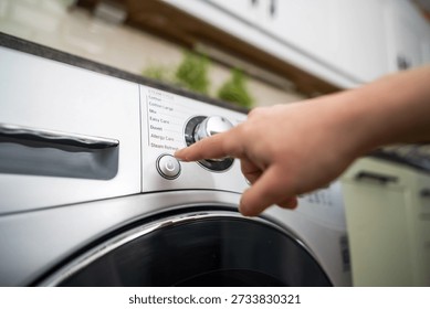 Washing machine. Pressing start button on modern washing machine display. Daily chores