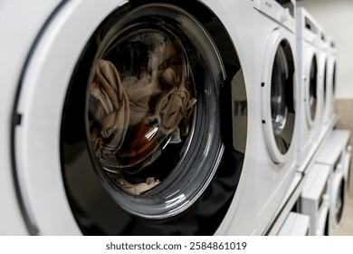 Washing machines, tumble dryer in a laundromat. industrial laundry equipment, energy efficient appliances, commercial laundry solutions, sustainable washing technology, hygienic washing environment