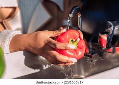 washing red pepper in the sink of a camper van - Powered by Shutterstock