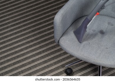 The Washing Vacuum Cleaner Cleans The Upholstery Of The Office Chair