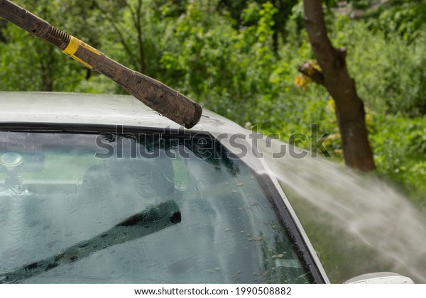 Washing\
the windshield from dirt. The car is washed by the pressure of the\
walls. Caring for vehicles after a muddy\
road.