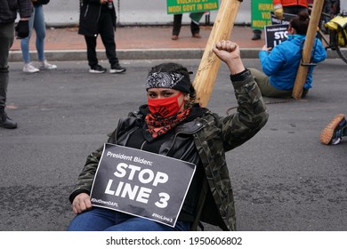 Washington, DC – April 1, 2021: A Defiant Line 3 Protester Raises Her Fist In An Effort To Shut Down The Line 3 Oil Pipeline.