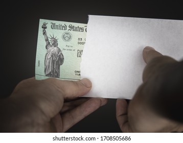 WASHINGTON DC - APRIL 19, 2020: United States Treasury check with envelope arriving in mail. Illustration for Economic Impact Payment (Stimulus Package) or tax refund to ease burden of Covid-19 virus.