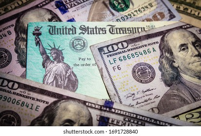 WASHINGTON DC - APRIL 2, 2020: United States Treasury Check With US Currency. Illustrates IRS Tax Refund Or Coronavirus Economic Impact Stimulus Payments To Taxpayers Affected By The Pandemic.