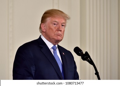WASHINGTON, DC - APRIL 27, 2018: President Donald Trump pauses as he speaks at a joint press conference with German Chancellor Angela Merkel in the East Room of the White House.