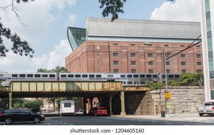 WASHINGTON, DC - AUG 31, 2018: Museum Of The Bible Frames Commuter Train Virginia Railway Express, On Railroad Bridge. Museum, Privately Owned, And Opened In 2017, Has Not Been Without Controversy.