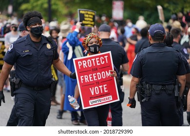 Washington, DC – August 02, 2021: Protesters being escorted by the Capitol Police after being arrested for blocking the street during the Voters Rights demonstration on Capitol Hill.