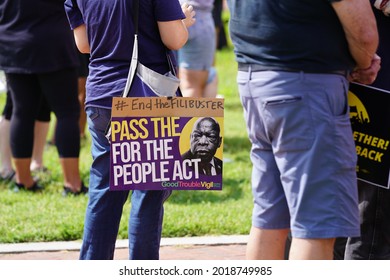 Washington, DC – August 02, 2021: A protester holds a sign with a photo of John Lewis at the Poor People's Campaign demonstration at Union Station.