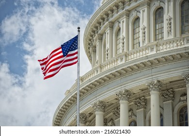Washington DC Capitol dome detail with waving american flag - Shutterstock ID 216021430